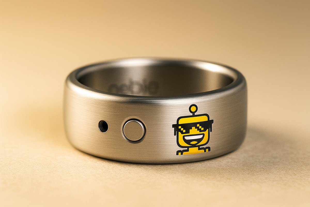 Close-up of a Pebble Index 01 smart ring with a tiny engraved SiliconSnark robot on its outer band.